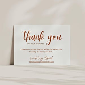 May include: A white card with the words "thank you" in a brown script font. The text "FOR YOUR PURCHASE" is below. Additional text reads "Thanks for supporting our small business! And trusting me with your Gift."
