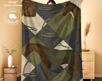 May include: A soft throw blanket measuring 50 inches by 60 inches, featuring a repeating pattern of brown horses, wooden buckets, and metal stirrups against a background of dark gray and olive green diamonds. The design includes equestrian gear.