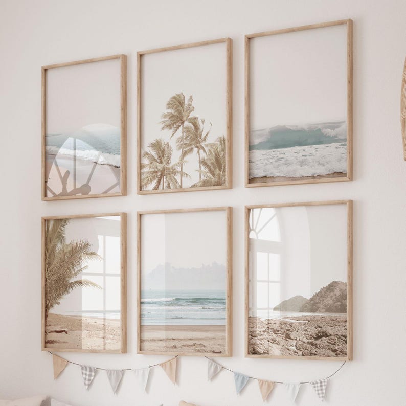 May include: A set of six framed prints featuring beach scenes. The prints are in a light wood frame and feature images of palm trees, waves, and sandy beaches.