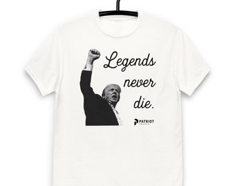 May include: White t-shirt with a black and white photo of a man raising his fist in the air. The text "Legends never die." is printed on the shirt. The logo "Patriot Church" is printed below the text.