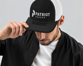 May include: A black and white trucker hat with a white mesh back. The front of the hat has a white embroidered logo that says "PATRIOT CHURCH".