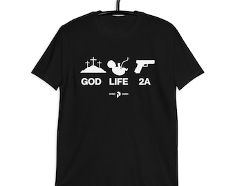 May include: Black t-shirt with a white graphic design. The graphic features a cross, a baby, and a gun with the words "God", "Life", and "2A" underneath. The words "Patriot Church" are printed below the graphic.