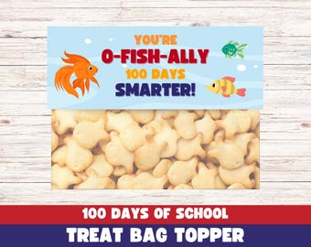 May include: A blue and orange treat bag topper with the text "You're O-Fish-Ally 100 Days Smarter!" and a picture of a goldfish and a blue fish. The topper also says "100 Days of School Treat Bag Topper".