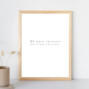 May include: A framed print with the text "HE must increase but I must decrease" in black font on a white background.