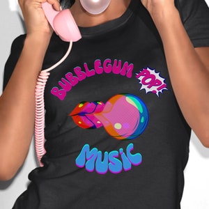 May include: A black t-shirt with a colorful graphic design featuring the words "Bubblegum Pop! Music" in a retro style. The graphic includes a pink and blue bubblegum with a pink lip.
