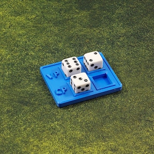 May include: A blue plastic tray with three white dice and the letters "VP" and "CP" printed on it.