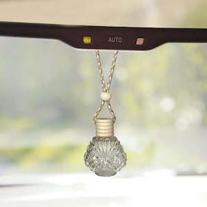 Trinity car/travel diffuser filled with organic herbaceous essential oils.