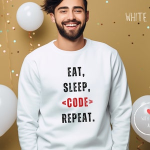May include: White sweatshirt with the text "Eat, Sleep, <CODE> Repeat." printed in black.