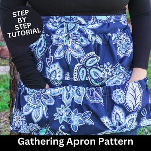 May include: A blue and white floral apron with a gathered skirt and pockets. The apron has a "Step by Step Tutorial" label.