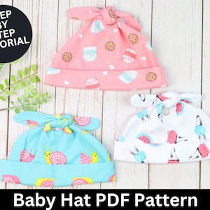 May include: Three baby hats with different patterns. The first hat is pink with a milk carton and cookie pattern. The second hat is blue with a snail pattern. The third hat is white with a watermelon and bunny pattern. The hats are on a white wooden background. Baby Hat PDF Pattern.