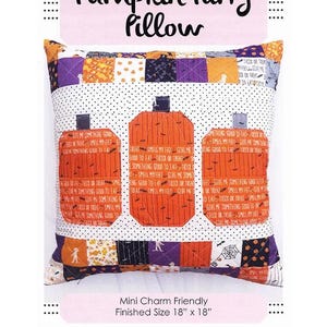 May include: A square Halloween-themed pillow with a patchwork design. The pillow features three orange pumpkin appliqués with the text "Treat Smell My Feet Give Me Something Good To Eat". The pillow measures 18 x 18 inches.