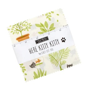 May include: A white fabric square with a green and brown cat and fish print. The fabric is labeled "Here Kitty Kitty" by Stacy Iest Hsu.