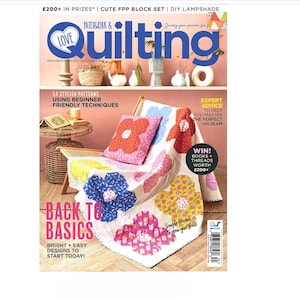 May include: A magazine cover for Quilting magazine featuring a colorful patchwork quilt with a floral design. The cover text reads "Back to Basics" and "Bright + Easy Designs to Start Today!"