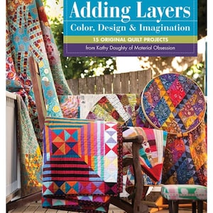 May include: A book titled "Adding Layers" with text about color, design, and imagination, featuring 15 original quilt projects. The image showcases various colorful quilts, including a large square quilt with geometric patterns and a round quilt in a wooden hoop.