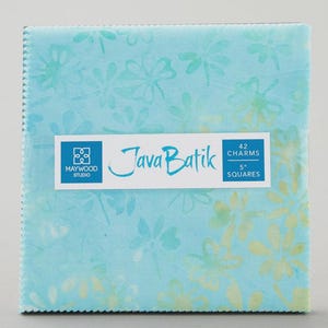 May include: A stack of 42 fabric squares labeled Java Batik by Maywood Studio. Each square measures 5 inches and features a light blue background with a repeating floral pattern in lighter shades of blue and pale yellow-green.