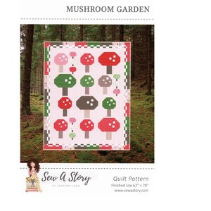 May include: A quilt pattern for a mushroom garden quilt. The pattern features a pink background with red, green, and brown mushrooms. The quilt is 62 inches by 78 inches. The pattern is called "Mushroom Garden" and is by Sew A Story.