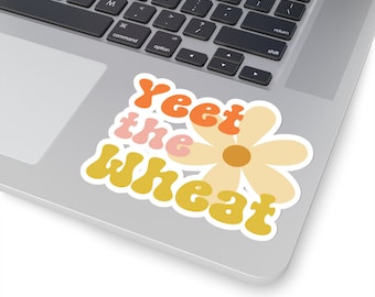 Puede incluir: Una pegatina con una margarita de estilo retro y el texto "Yeet the Wheat" en naranja, amarillo y rosa.