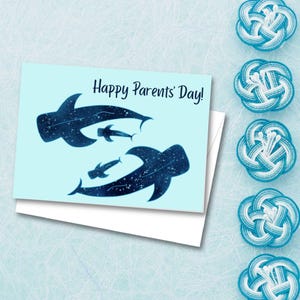 May include: A light blue greeting card with the text "Happy Parents' Day!" features dark blue whale shark illustrations. Several decorative blue and white knots are arranged on the right side of the image.