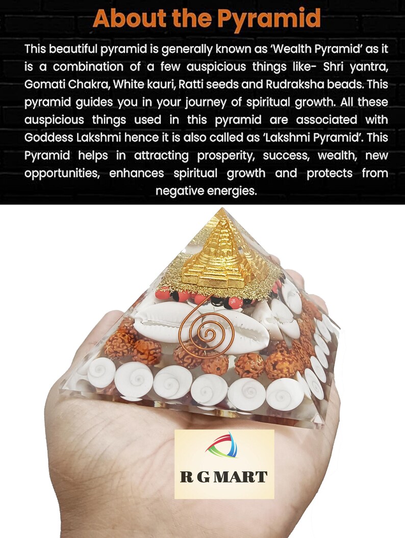 May include: A clear glass pyramid filled with various items, including white seashells, red and brown beads, and a gold-colored Shri Yantra. The pyramid is being held in a hand. The text "RG MART" is visible in the lower right corner of the image.