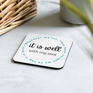 May include: Square white coaster with the text "it is well with my soul" in black script. The phrase "Whatever my lot, Thou hast taught me to say it is well" is in a teal circle around the text.