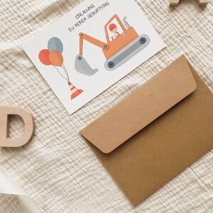 May include: A brown envelope with a white card on top. The card has a cartoon illustration of a construction worker driving a yellow excavator with a grey bucket. The card also has three balloons and a traffic cone. The text on the card reads "Einladung zu meinem Geburtstag".