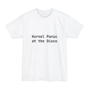 May include: White t-shirt with the text "Kernel Panic at the Disco" printed in black. The shirt has a crew neck and short sleeves. The text is centered on the front of the shirt.