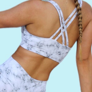 May include: A white and gray marble print sports bra with criss-cross straps in the back. The bra is part of a matching set with leggings.  ZYLA SEWING PATTERNS. Instant PDF download.