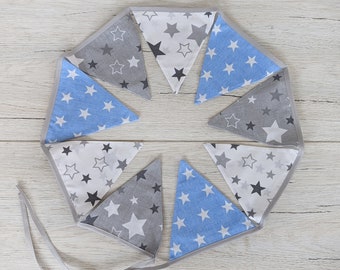 May include: A blue and gray fabric bunting with stars printed on each flag. The bunting is strung together in a circle.
