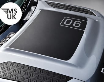 May include: A silver vehicle hood featuring a large matte black central decal with the number 06 printed in white. The hood includes black diamond-plate textured panels on the sides and a circular logo in the corner displaying the text MS UK.