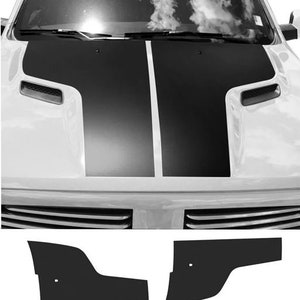 May include: Black and white vinyl hood stripes for a car. The stripes are designed to fit a Dodge Challenger. The stripes are made of high-quality vinyl and are easy to apply.