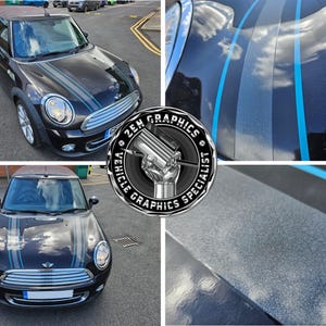 May include: A black Mini Cooper with blue and gray racing stripes. The car has a glossy finish and is parked on a paved surface. The image includes a logo that says "ZEN GRAPHICS VEHICLE GRAPHICS SPECIALIST."