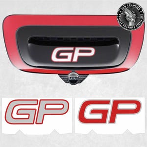 May include: A set of two red and grey "GP" decals for a Mini Cooper. The decals are designed to be placed on the rear of the car, above the number plate.