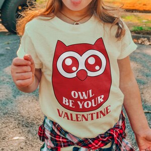 a little girl wearing a owl be your valentine shirt