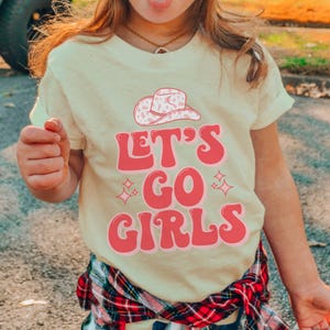 a little girl making a funny face with her tongue