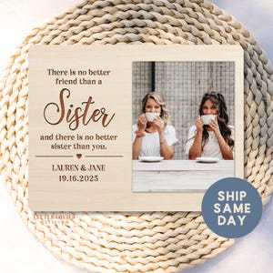 May include: Wooden photo frame with the words "There is no better friend than a Sister and there is no better sister than you." The frame includes a photo of two women drinking from white mugs. The names "LAUREN & JANE" and the date "19.16.2025" are also on the frame.