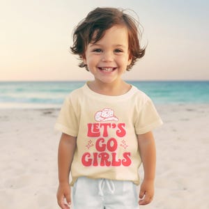 a little boy that is standing in the sand