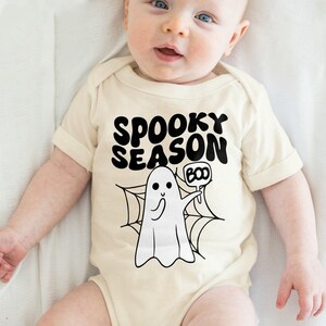 a baby wearing a spooky season shirt