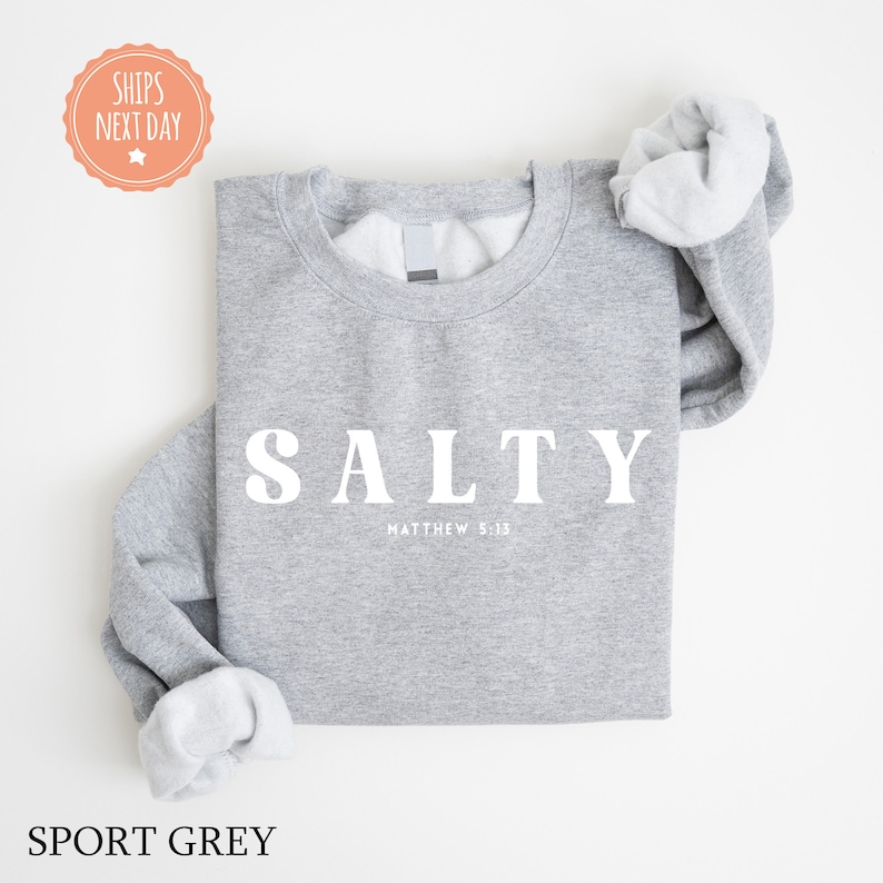 a gray sweatshirt with a white slogan on it