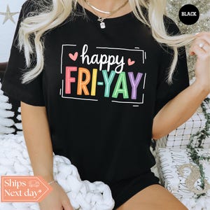 May include: Black t-shirt with a rainbow graphic that says "happy FRI-YAY" with pink hearts on either side of the word "happy".