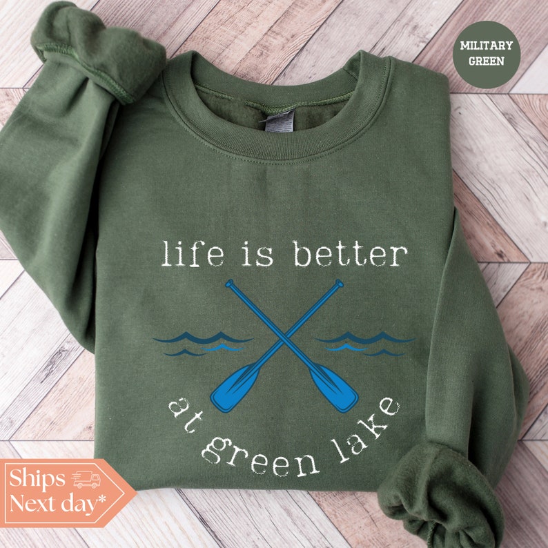 a green sweatshirt with two crossed oars and the words life is better at green