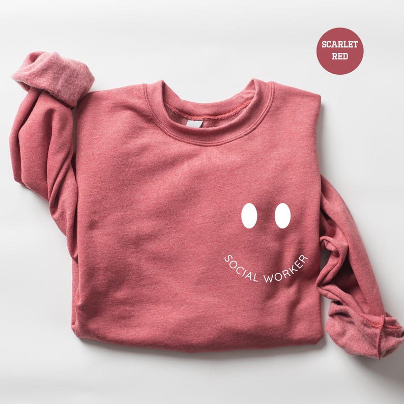 a pink sweater with a face drawn on it