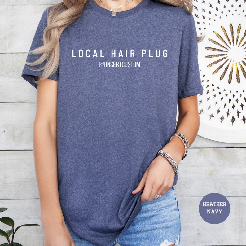 a woman wearing a local hair plug t - shirt
