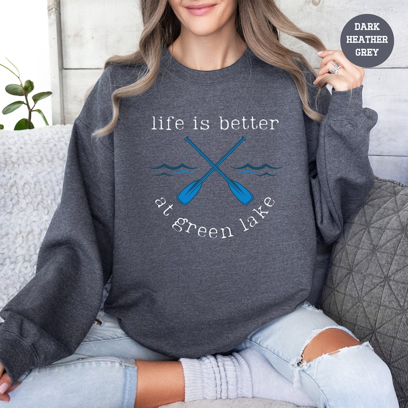 a woman wearing a sweatshirt that says life is better at green lake