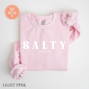 a pink sweatshirt with the word salty on it