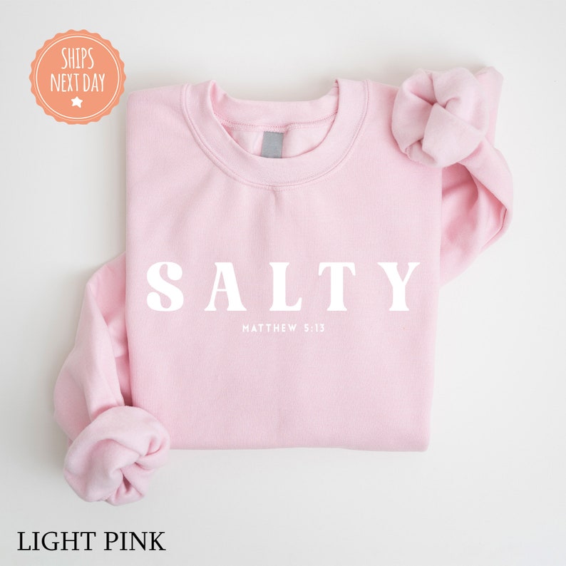 a pink sweatshirt with the word salty on it