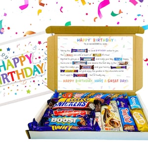 May include: A birthday gift box containing assorted chocolate bars such as Snickers, Boost, and Galaxy. The box is decorated with confetti and includes a card with a birthday message.