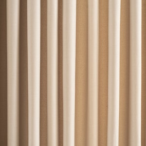 May include: A close-up of a set of beige and brown curtains with vertical stripes. The curtains are made of a soft, textured fabric.