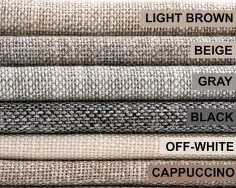 May include: Close-up of fabric swatches in various colors, including light brown, beige, gray, black, off-white, cappuccino, and green. The swatches are stacked on top of each other.