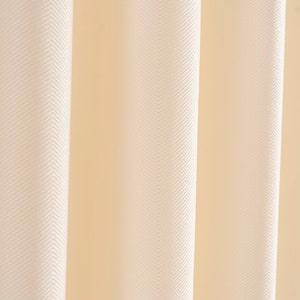 May include: Close-up of a white fabric with a herringbone pattern. The fabric has a soft, smooth texture.