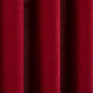 May include: Close-up of a deep red fabric with a textured woven pattern. The fabric has a subtle sheen and is slightly wrinkled.